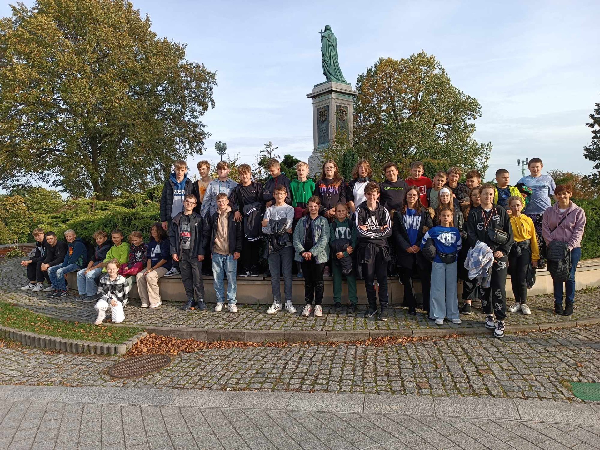 Uczniowie z opiekunami stoją na tła pomnika o. Kordeckiego